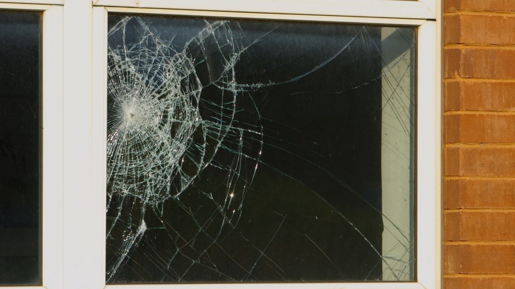 A cracked and damaged window