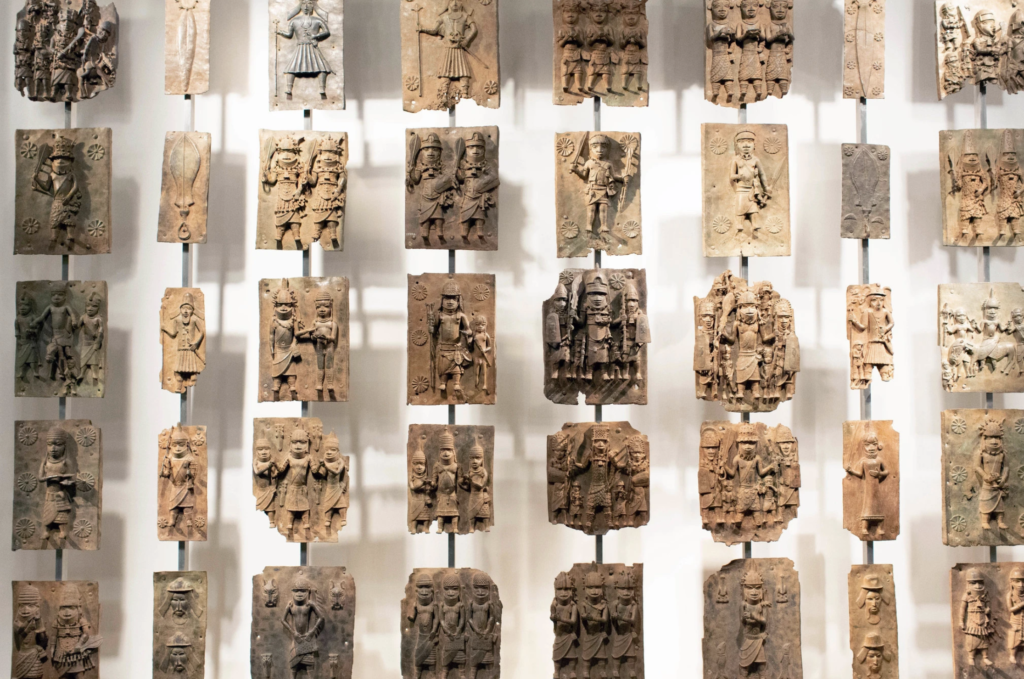 Bronzes from 16th century Benin. A a group of sculptures including decorated cast plaques, commemorative heads, animal and human figures, items of royal regalia, and personal ornaments.