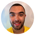 Article author Liam smiles at the camera. He is dual-heritage and wears a bright yellow t-shirt.