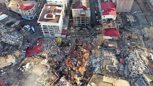 An overhead photograph of destroyed buildings, whole blocks of flats are completely flattened