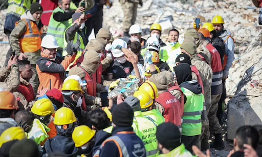 A crowd of people helping rescue a young boy