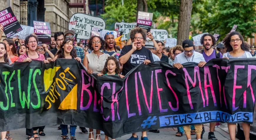 BLM protesters. The banner reads - Jews Support Black Lives Matter