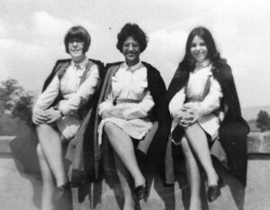 Old black and white photograph of 3 women in NHS uniforms. One of the women is dark skinned.