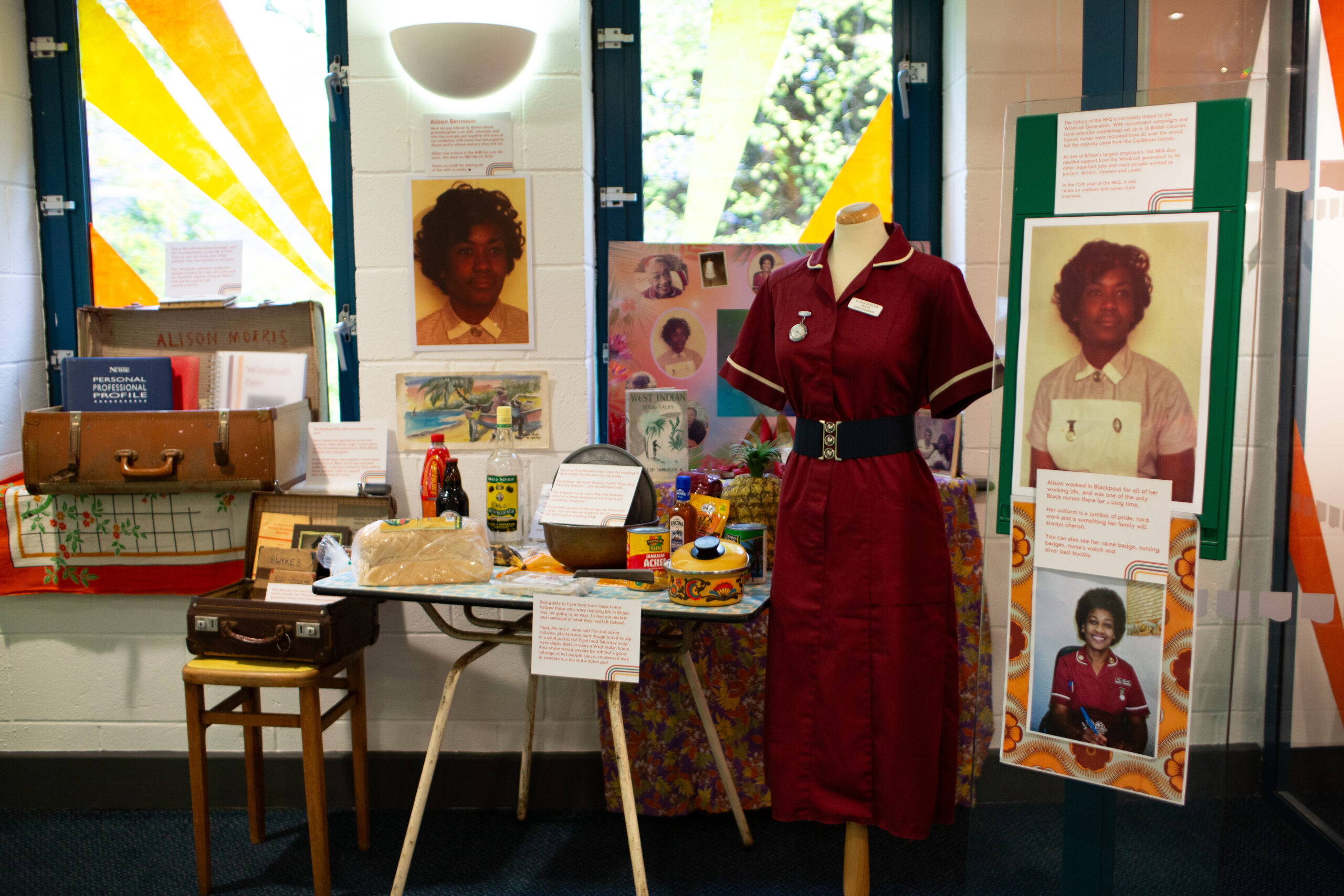 A variety of items exhibited that celbrate Windrush. Including a maroon nurses uniform.